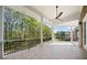 Spacious covered patio with tile flooring and a ceiling fan offering picturesque backyard views at 1660 Norris Landing Dr, Snellville, GA 30039