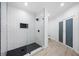Modern shower with black and white tile, frameless glass enclosure, and sleek fixtures at 1660 Norris Landing Dr, Snellville, GA 30039