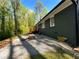 Landscaped backyard featuring a fire pit, deck, and access to nature at 185 Maple Wood Dr, Lawrenceville, GA 30046