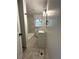 Bathroom with modern vanity and decorative light fixture and combination shower and tub with marble tile surround at 185 Maple Wood Dr, Lawrenceville, GA 30046
