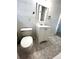 Bathroom featuring a white vanity, toilet, and updated flooring, creating a clean and functional space at 185 Maple Wood Dr, Lawrenceville, GA 30046