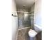 This bathroom features a stylish shower with marble-style tile and convenient built-in shelving at 185 Maple Wood Dr, Lawrenceville, GA 30046