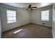 Bright bedroom with two windows providing natural light, complemented by neutral carpeting and a ceiling fan at 185 Maple Wood Dr, Lawrenceville, GA 30046