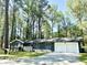 Ranch-style home with brick and siding exterior, 2-car garage, and mature trees at 185 Maple Wood Dr, Lawrenceville, GA 30046