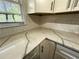 Bright kitchen features quartz countertops with white cabinets and subway tile backsplash at 185 Maple Wood Dr, Lawrenceville, GA 30046