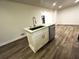 Kitchen island with breakfast bar and sink, alongside stainless steel dishwasher at 185 Maple Wood Dr, Lawrenceville, GA 30046