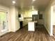 Updated kitchen featuring stainless steel appliances, a tile backsplash, and an island at 185 Maple Wood Dr, Lawrenceville, GA 30046