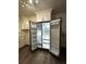 Open refrigerator showing ample storage in a bright kitchen with white cabinetry at 185 Maple Wood Dr, Lawrenceville, GA 30046