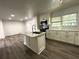 Spacious kitchen boasts an island with a sink, modern appliances, and stylish subway tile at 185 Maple Wood Dr, Lawrenceville, GA 30046