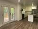 Renovated kitchen with white cabinets, stainless steel appliances, and wood floors at 185 Maple Wood Dr, Lawrenceville, GA 30046