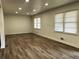 Spacious living room filled with natural light, wood floors, and neutral walls at 185 Maple Wood Dr, Lawrenceville, GA 30046