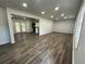 Open-concept living room featuring recessed lighting, wood floors, and access to the deck at 185 Maple Wood Dr, Lawrenceville, GA 30046