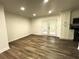 Living area with wood floors and access to a patio and the kitchen at 185 Maple Wood Dr, Lawrenceville, GA 30046