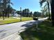 View of a long driveway leading to a grand, traditionally-styled estate at 185 Maple Wood Dr, Lawrenceville, GA 30046