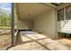 View of the spacious carport with a blue area rug and a door leading into the house at 5026 Daniel Mill Rd, Winston, GA 30187