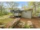 View of an exterior with a screened-in porch, stone accent, and lush landscaping at 5026 Daniel Mill Rd, Winston, GA 30187