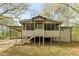 Inviting exterior showcasing a charming tan home with a screened-in porch and convenient carport at 5026 Daniel Mill Rd, Winston, GA 30187