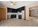 The eat-in kitchen features black cabinets, stainless appliances, and tile flooring at 5026 Daniel Mill Rd, Winston, GA 30187