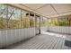 Screened-in porch with gray wood flooring and natural views, providing a relaxing outdoor space at 5026 Daniel Mill Rd, Winston, GA 30187
