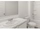Clean bathroom with a marble-look countertop, white cabinetry, and a shower-tub combo with white tiles at 604 Lobelia Way, Locust Grove, GA 30248