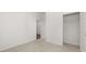 Well-lit bedroom with neutral carpet, closet, and doorway to another room at 604 Lobelia Way, Locust Grove, GA 30248
