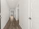 Open hallway featuring hard wood floors and access to various rooms at 604 Lobelia Way, Locust Grove, GA 30248