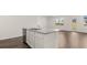 Bright, open kitchen featuring a large island with stainless steel sink at 604 Lobelia Way, Locust Grove, GA 30248