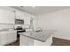 Close up view of an island with granite countertops and stainless steel appliances at 604 Lobelia Way, Locust Grove, GA 30248