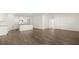 Open-concept living room flows into the kitchen, offering both style and functionality at 604 Lobelia Way, Locust Grove, GA 30248