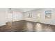 Spacious living room with wood-look flooring, and windows that offer natural light at 604 Lobelia Way, Locust Grove, GA 30248