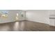 Bright living room features wood-look flooring, natural light, and access to the outdoors at 604 Lobelia Way, Locust Grove, GA 30248