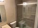 Bathroom with a glass-enclosed shower with a built-in seat and grab bars at 1241 Baldridge Dr, Lawrenceville, GA 30044
