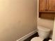Powder room featuring a toilet and small built in cabinet at 1241 Baldridge Dr, Lawrenceville, GA 30044