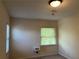 Neutral bedroom featuring a window, light fixture, and light carpet at 1241 Baldridge Dr, Lawrenceville, GA 30044