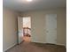 Bedroom view features neutral paint, light carpet, and an open doorway at 1241 Baldridge Dr, Lawrenceville, GA 30044