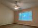 Cozy bedroom with a ceiling fan and large bay window overlooking the outdoor landscape at 1241 Baldridge Dr, Lawrenceville, GA 30044