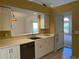Open-concept kitchen with white cabinetry, a dishwasher, and view into the breakfast nook at 1241 Baldridge Dr, Lawrenceville, GA 30044