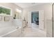 Relaxing bathroom includes a soaking tub with marble surround, double sink vanity, and an ensuite bedroom at 160 Avery Landing Way, Canton, GA 30115