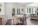 Cozy breakfast nook with a marble table, upholstered bench seating, and sliding doors to an outdoor patio at 160 Avery Landing Way, Canton, GA 30115