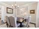 Inviting dining room featuring a wood table, upholstered seating, chandelier and decorative wall decor at 160 Avery Landing Way, Canton, GA 30115