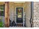Welcoming front entrance with a decorative wreath, sidelights, and a charming doormat at 160 Avery Landing Way, Canton, GA 30115