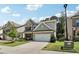 Charming two-story home with a brick facade, well-manicured lawn, and a two-car garage on a sunny day at 160 Avery Landing Way, Canton, GA 30115