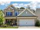 Charming two-story home with brick and siding exterior, a well-manicured lawn, and attached garage at 160 Avery Landing Way, Canton, GA 30115