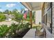 Inviting front porch with brick columns, a cozy bench, and lush landscaping at 160 Avery Landing Way, Canton, GA 30115