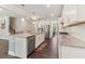 Bright kitchen featuring an island with bar seating, granite countertops, stainless appliances and dark wood floors at 160 Avery Landing Way, Canton, GA 30115