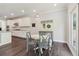 Bright breakfast nook with a round table, bench seating, and view of kitchen with white cabinetry at 160 Avery Landing Way, Canton, GA 30115
