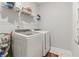 Bright laundry room equipped with modern washer and dryer appliances for convenient chores at 160 Avery Landing Way, Canton, GA 30115