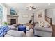 Cozy living room featuring a stone fireplace, plush sofas, and a ceiling fan at 160 Avery Landing Way, Canton, GA 30115