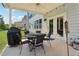 Outdoor dining with a grill on the covered patio with string lights at 160 Avery Landing Way, Canton, GA 30115