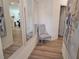 Inviting hallway featuring wood floors, elegant mirrors, and stylish decor creating a welcoming entrance at 2690 Ne Almand Ln, Conyers, GA 30013